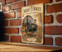 A vintage-style metal sign featuring a turkey in an autumn forest setting, mounted on a brick wall.
