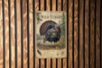 A vintage-style metal sign featuring a detailed illustration of a wild turkey, mounted on a wooden wall.