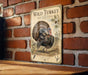 A vintage-style metal sign featuring a detailed illustration of a wild turkey, mounted on a brick wall.