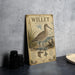 A vintage-style metal plate featuring an illustration of a bird, likely a stork, standing on a beach with a textured background.