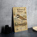 A vintage-style metal plate with an illustration of a sandpiper bird, labeled as Wilson's Plover, standing on a beach.