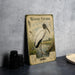 a vintage-style illustration of a wood stork standing in a grassy area near a body of water, with a plate of food and a camera on a table in the foreground.