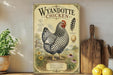 A vintage-style poster of Wyandotte chicken is displayed on a shelf, accompanied by a wooden cutting board, a potted plant, and some lemons.