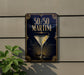 A sign for a 50/50 martini cocktail is displayed on a wall, with a plant visible to the left.