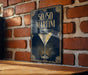 A sign with the text "50/50 Martini" and an illustration of a martini glass on a brick wall.