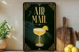 a decorative sign with the text "AIR MAIL" and an illustration of a cocktail glass with a lime slice.