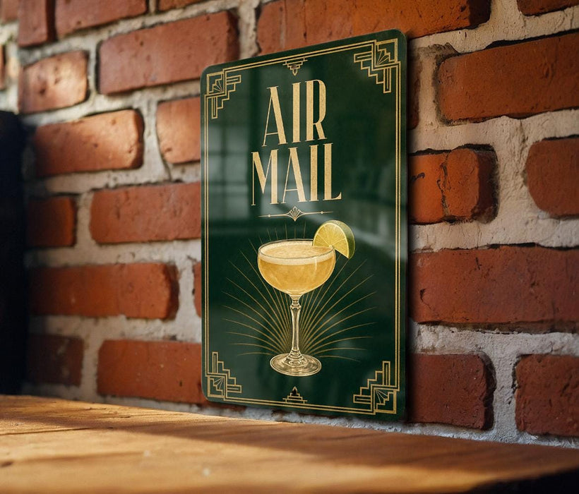 a sign with a cocktail glass and a lemon slice, mounted on a brick wall.