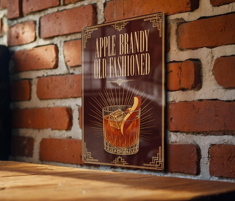 a sign with the text "Apple Brandy Old Fashioned" and an illustration of a glass of whiskey with an apple slice.