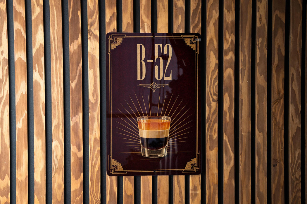 A sign with the text "B-52" and an image of a layered coffee drink is displayed on a wooden wall.