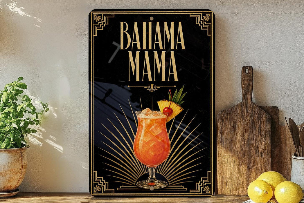 A decorative sign with the text "BAHAMA MAMA" and an illustration of a colorful drink, placed on a wooden surface next to a potted plant and a cutting board.