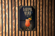 A sign for a tropical drink called "BAHAMA MAMA" is displayed on a wooden wall.