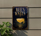 a sign that reads "BEES KNEEES" with a picture of a cocktail glass and a lemon peel on it.