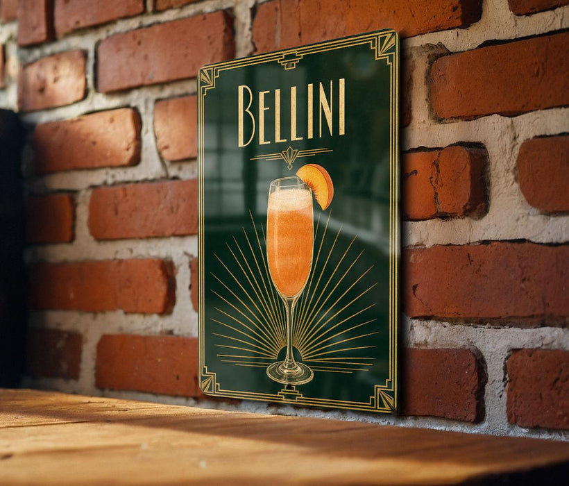 A poster of a champagne glass with a slice of orange on a brick wall.