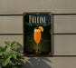 A sign for "Bellini" cocktail, featuring an illustration of a glass of orange drink with a slice of orange on the side, against a dark background with a decorative border.