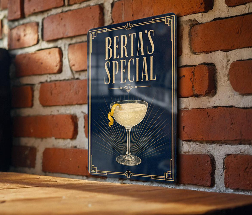 A sign for "Berta's Special" cocktail, featuring an illustration of a cocktail glass with a lemon twist.