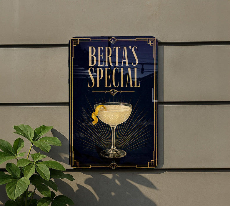 A sign for "Berta's Special" cocktail, featuring a glass illustration and a lemon twist, is displayed on a wall.