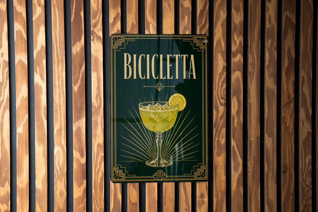 A sign for a bar called "Bicyclette" with a glass illustration and decorative elements.