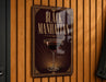 A sign that reads "Black Manhattan" with an illustration of a martini glass.
