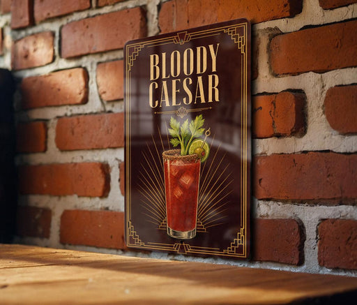 A framed image of a Bloody Caesar cocktail on a brick wall.