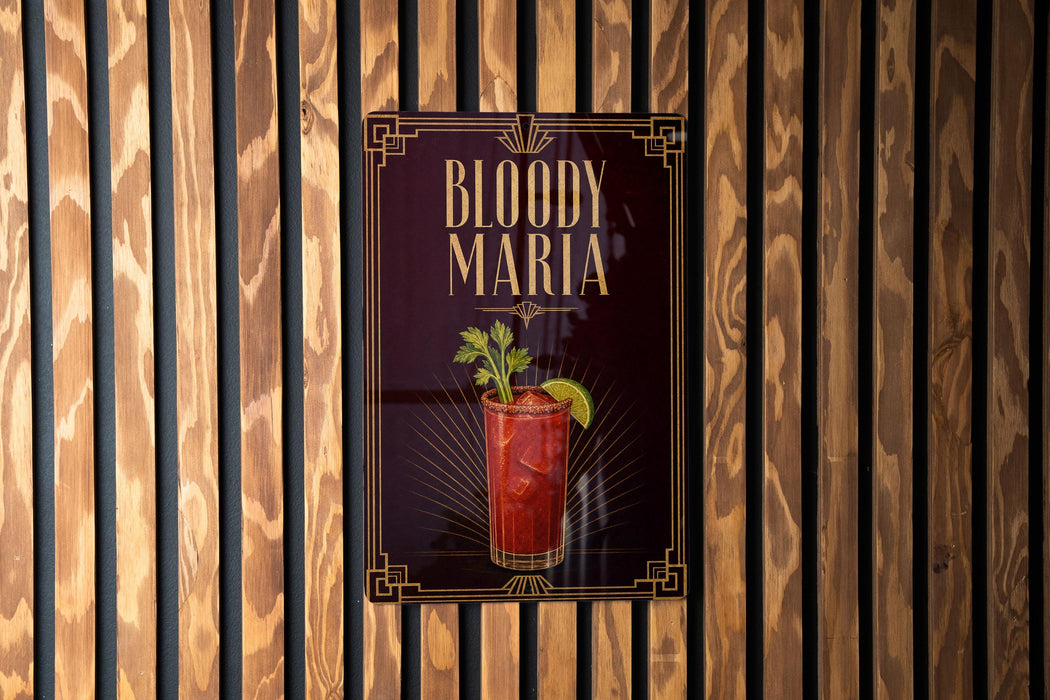 A poster for "Bloody Maria" cocktail is displayed on a wooden wall.