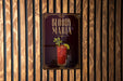 A poster for "Bloody Maria" cocktail is displayed on a wooden wall.