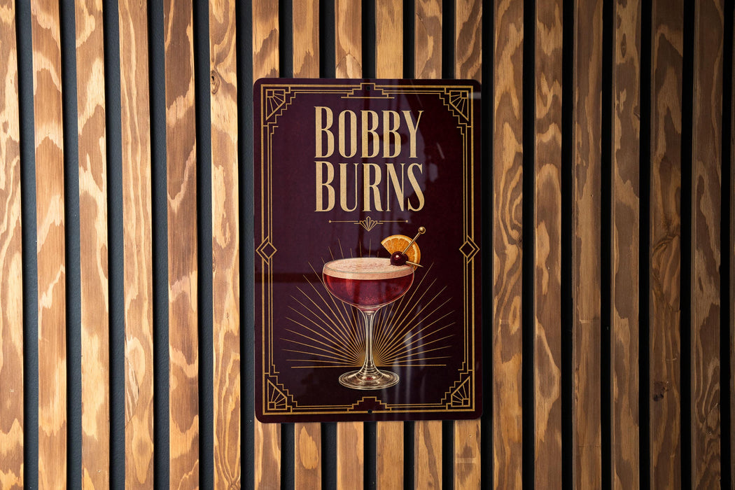 A sign for "Bobby Burns" cocktail is displayed on a wooden wall.