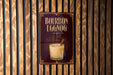 A sign for "Bourbon Eggnog" is displayed on a wooden wall.
