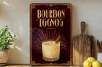 A vintage-style advertisement for a cocktail called "Bourbon Eggnog" is displayed on a wall, featuring a glass of eggnog with a cinnamon stick.