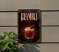 a decorative sign for a drink called "Bramble" with a glass illustration and a garnish on top.