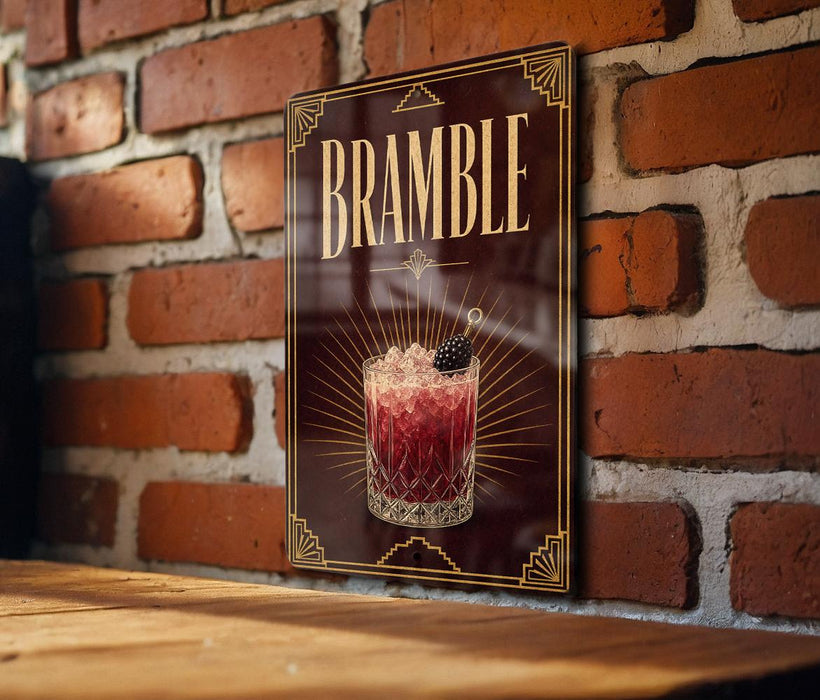 A decorative sign for a drink called "Bramble" is displayed on a brick wall.