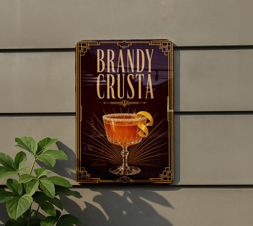 A sign for "Bandy Crusta" is displayed on a wall, featuring an illustration of a glass containing a cocktail with a lemon twist.