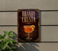 A sign for "Bandy Crusta" is displayed on a wall, featuring an illustration of a glass containing a cocktail with a lemon twist.