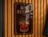 A sign for Brandy Old Fashioned, featuring an illustration of a glass of amber-colored liquor with a slice of orange peel.