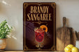 A decorative sign for "Brandy Sangaree" is displayed on a wooden shelf, accompanied by a potted plant, a cutting board, and some lemons.