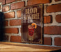 A sign for "Bandy Sangaree" is displayed on a brick wall, featuring an illustration of a cocktail with an orange slice.