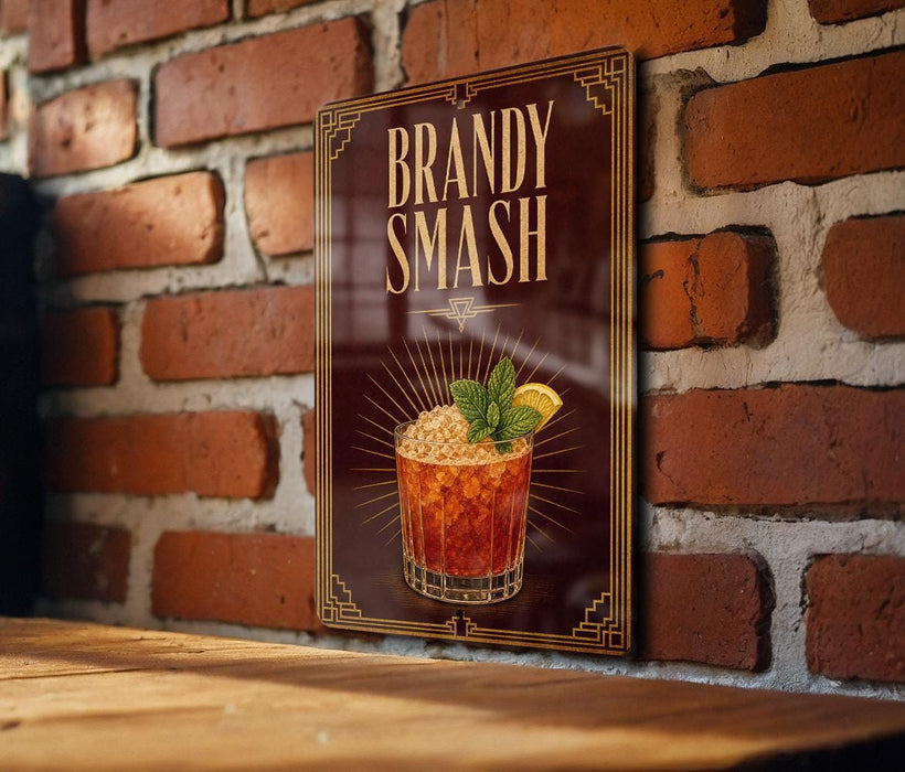 A framed illustration of a cocktail with a garnish, displayed on a brick wall.