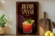 A framed advertisement for a "Brandy Smash" cocktail, featuring a glass of the drink with a lemon slice and mint garnish.