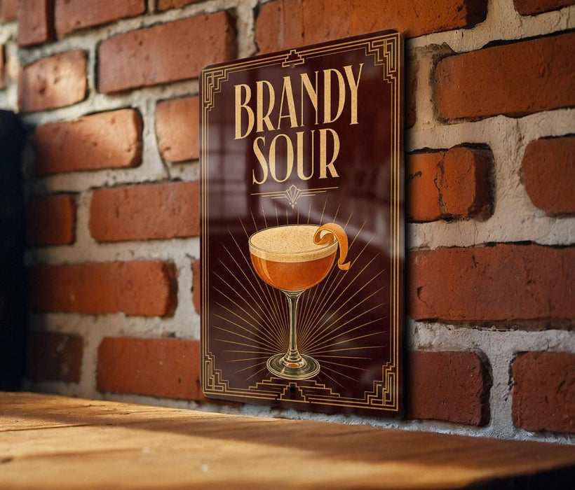 A poster or sign with the text "BRANDY SOUR" and an illustration of a cocktail glass with a lemon peel.
