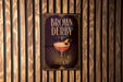 A poster for "Brown Derby" is displayed on a wooden wall.