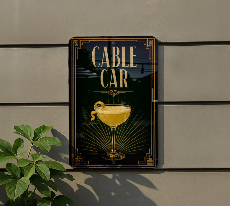 a sign for a bar called "Cable Car" with a glass of yellow liquid and a lemon on the sign.