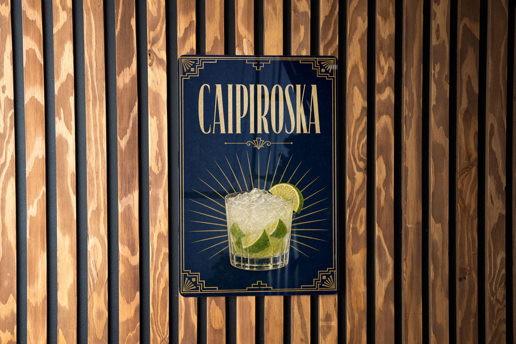 A sign for a Caipiroski cocktail is displayed on a wooden wall.