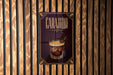 a sign for a drink called "Carajillo" with a glass illustration and ice cubes.