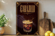 a sign for Carañilo, a cocktail, with a glass of Carañillo and ice cubes displayed on a wooden surface.