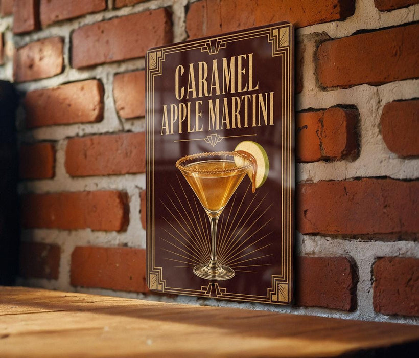 A sign for a caramel apple martini is displayed on a brick wall.