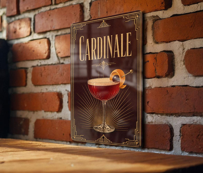 A decorative sign with the word "Cardinale" on it, featuring an illustration of a cocktail glass with a lemon twist.