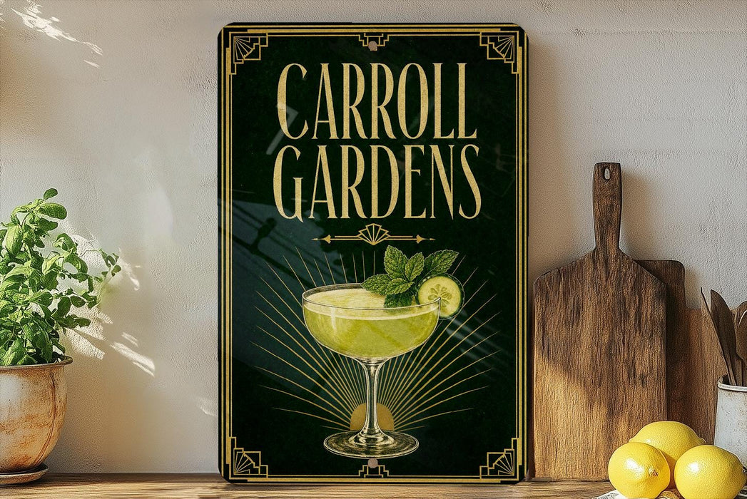 A framed poster advertising Carroll Gardens, featuring a cocktail glass with a lemon slice and mint leaves, is displayed on a shelf next to a wooden cutting board and a potted plant.