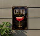 a sign for a cocktail called "Castaway" with a glass illustration and decorative elements.