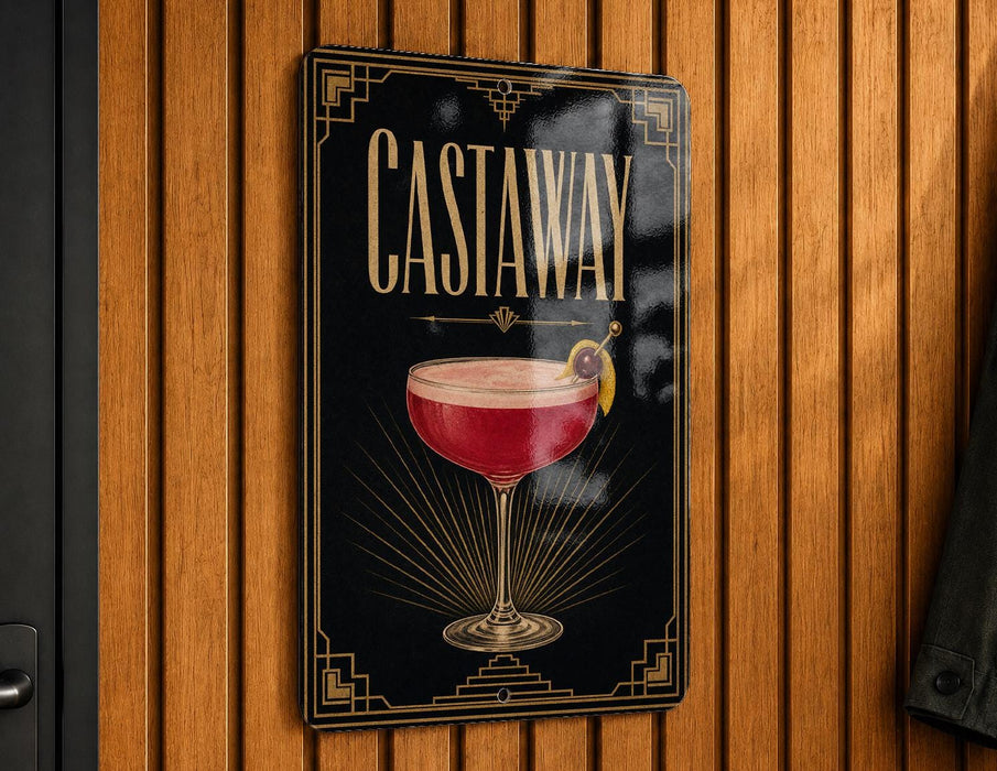 A sign for "Castaway" cocktail, featuring a glass illustration of a red drink with a garnish on a black background with gold and white decorative elements.