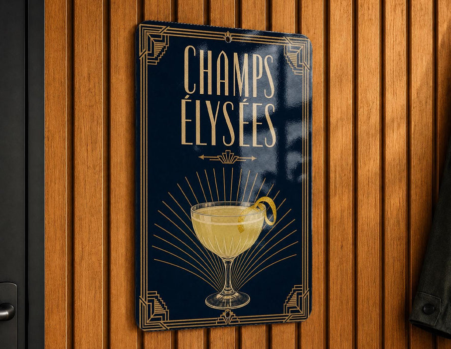 A sign with the text "CHAMPS ELYSEES" and an illustration of a cocktail glass with a lemon twist.