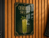 A sign for a Chartreuse Swizzle cocktail is displayed on a wooden wall.